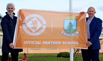 Kingspark Headmaster Paul Dow and Community Trust Chairman David Dorward unfurl the School Partnership flag
